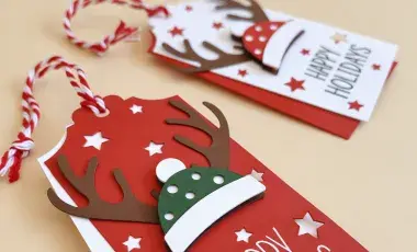 DYI Cricut made present tags featuring festive hats with antlers expressing "Happy Holidays"" 