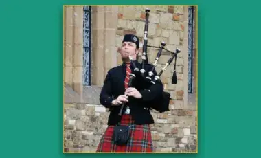John McLean Allan playing the Scotland bagpipes dressed in his clan's tartans.