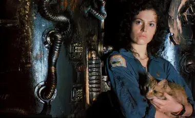 Sigourney Weaver in uniform as Ripley pictured holding her tabby cat