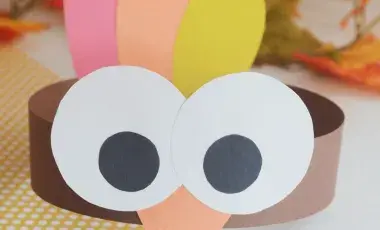 A turkey with big eyes made out of paper.