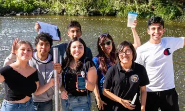 teens participating in a water transparency exercise by the LA River