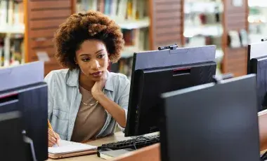 a woman sitting in front of a computer