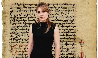 person standing, imposed on ancient manuscript