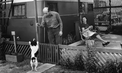 Residents of space 23 at the Olympic Trailer Court  in Santa Monica relax outside of their trailer