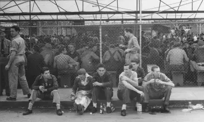Workers are shown during a lunch break at the Lockheed Corporation aircraft plant in Burbank