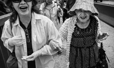 Two older people linking arms