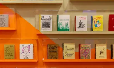 Shelves showcasing cookbooks from the L.A. Community Cookbook Archive.