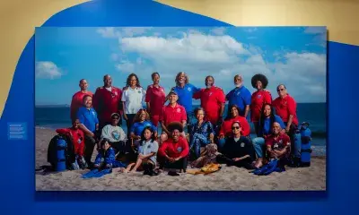 A large photo of the members of the L.A. Black Underwater Explorers, hung on the wall of the Something in Common exhibit.