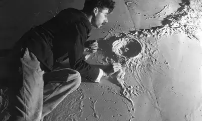 Person with plaster scale model of moon