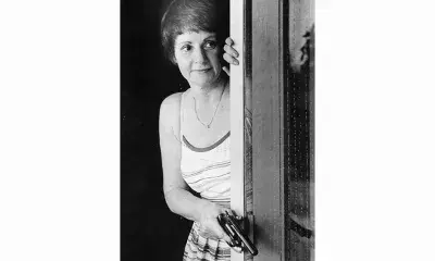 Los Angeles resident, frightened by the Night Stalker holds her gun