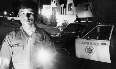 cop with flashlight at night