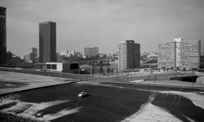"Ready for Redevelopment" 1971 - William Reagh Collection. A lone 1956 Ford points towards the Bunker Hill Towers from the graded lots between Hope, Grand, 2nd, and 3rd which are awaiting redevelopment