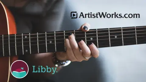 hand holding a guitar
