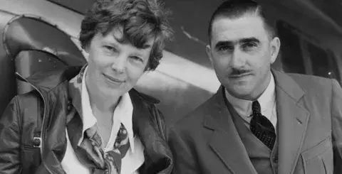 Amelia Earhart and technical expert Paul Mantz study the route Earhart undertook in a flight from the Hawaiian Islands to California, the longest over-water flight ever undertaken at that time.