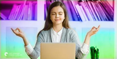 Young girl facing her laptop in a stress-free pose