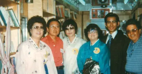 Korean Americans and library staff inside a Los Angeles Public Library Bookmobile that is participating in an annual Korean parade.