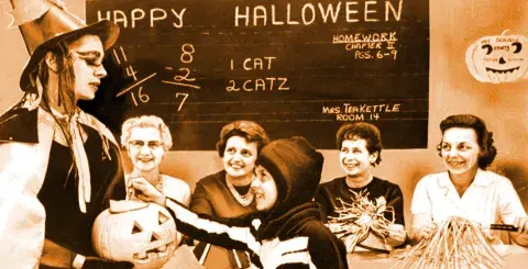 Judy Aldrich, 8, receives pumpkin treat from Donna Lewis