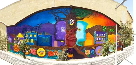 Tia Chucha's Cultural Center & Bookstore's mural depicting the tree of life, the masculine/feminine generating principles of the world, and the wholeness of self, community, earth, and spirit.