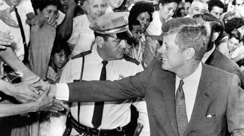 John Kennedy Shaking Hands in Crowd