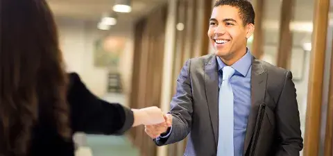 man shaking a hand of another business person after an interview