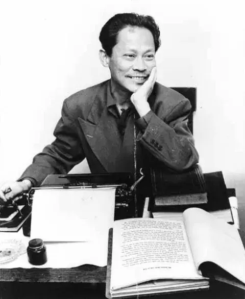 Man at desk with book open