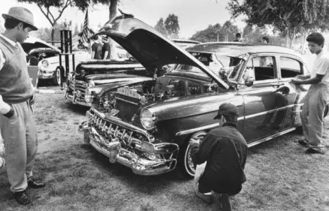 photo of men working on car