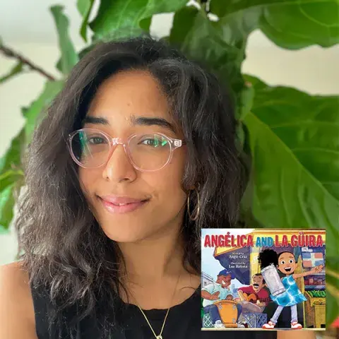 Liz Batista with a cover of her book
