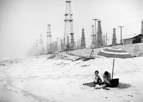 beach with oil derricks