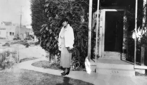 Crystal Marshall in front of the family home