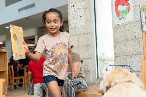 child holds book