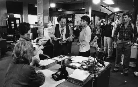 Actress Tyne Daly waits with costars for the director to call places