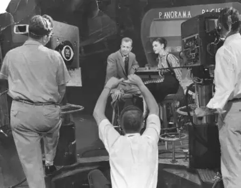 Red Rowe, host of Panorama Pacific, gets a signal from KNXT stage manager Buddy Morrison