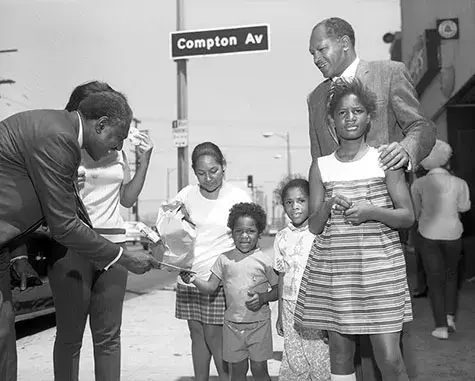 Wilson Riles campaigns for California State Superintendent of Public Instruction with Councilman Tom Bradley outside of Magnificent Bros Hair Salon 2, located at 1568 E. 103rd Street in Watts. 