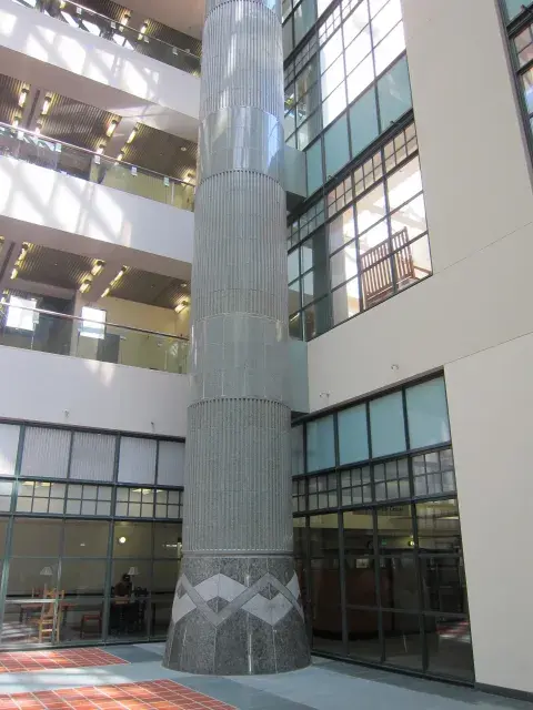 The magnificent atrium columns envelop steel posts with glazed terra cotta, accented by the ubiquitous chevrons. The design was inspired by Julian Garnsey