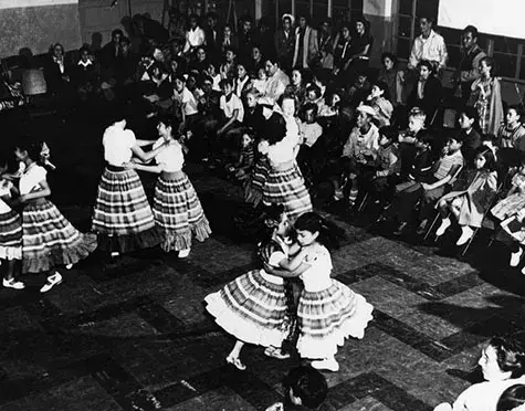 Girls in Mexican costumes perform a dance at a Cinco de Mayo celebration at the William Mead Homes Housing Project. 