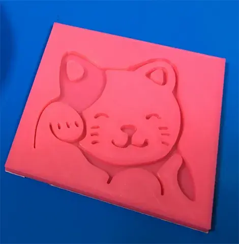 3D printed pink waving cat