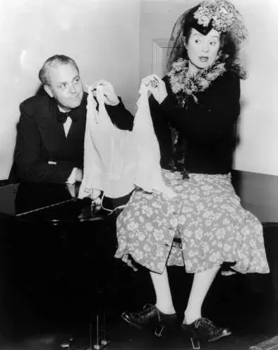 Elsa Lanchester holding an article of women