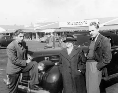 Richard Brandon, Mrs. Brown and Forman Brown near their car in the parking lot of Farmers Market in 1946