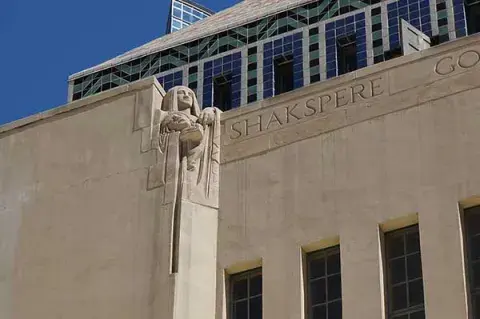 Allegorical figure of Shakespeare on library facade