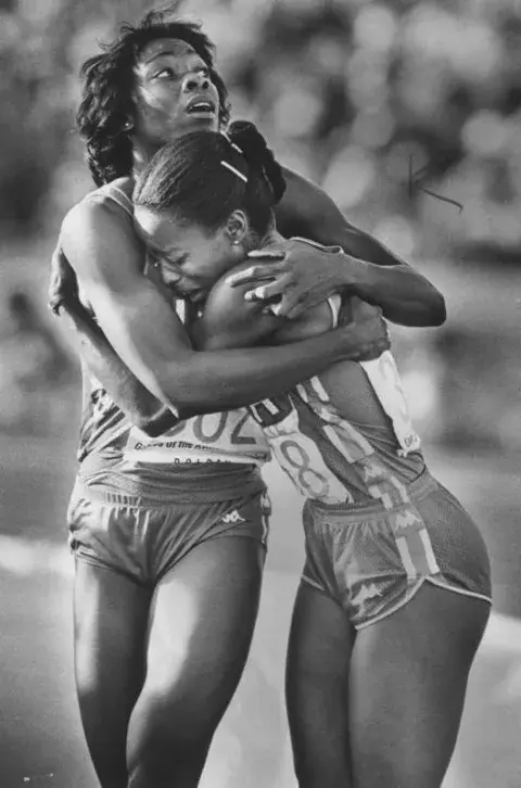 Evelyn Ashford (right), hugs teammate Jeanette Bolden