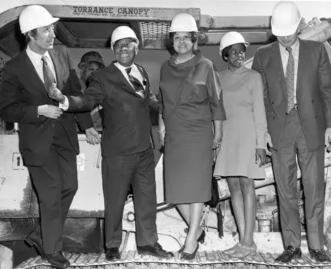 Commissioners and City Librarian in hard hats at groundbreaking of the Vernon Branch