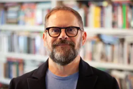 Colin Campbell in fron of his library