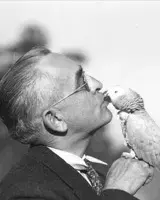 odler man kissing a parrot