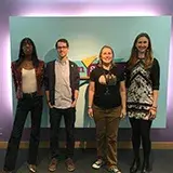 4 librarians in front of the Teenscape sign