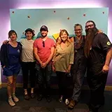 6 artisans in front of the Teenscape sign
