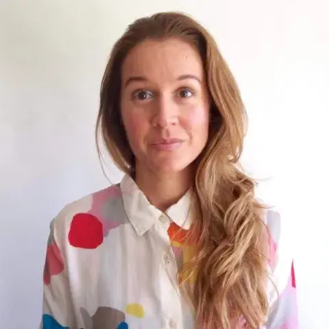 Danielle Davis in a polka dot blouse