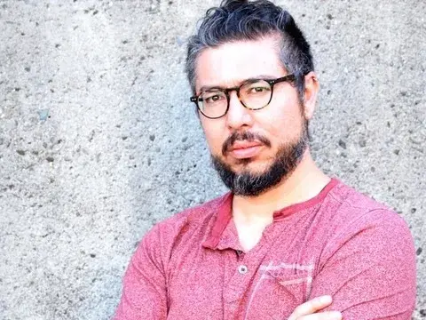 J. Michael Martinez in a rose colored t shirt