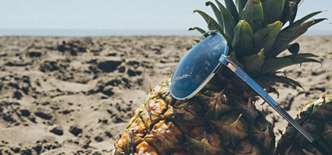 A pineapple at the beach wearing sunglasses. Image courtesy of Pexels from Pixabay.
