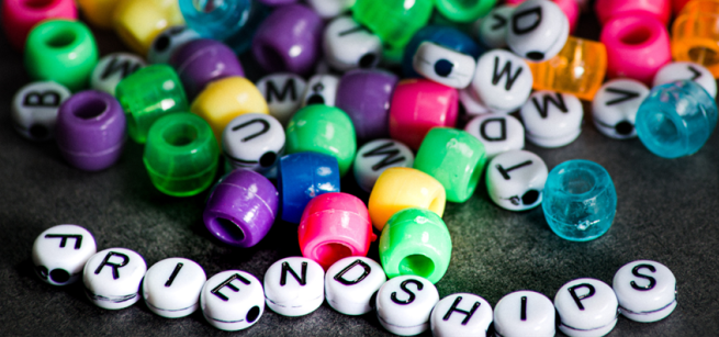 Colorful beads, along with alphabet beads at the bottom that spell "Friendship" 