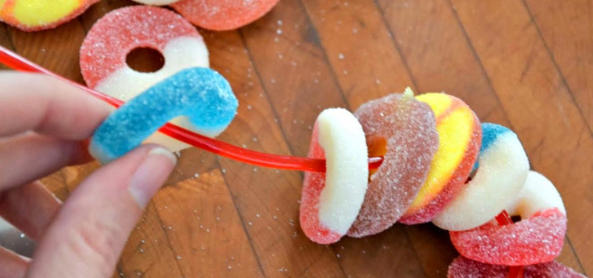 fingers holding gummy jewelery